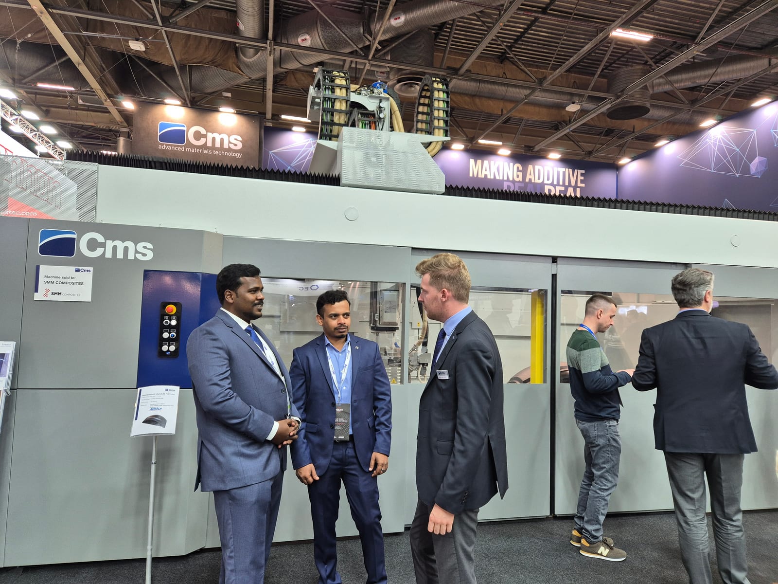 ABS India and CMS team in front of the CMS additive manufacturing machine, JEC World 2024