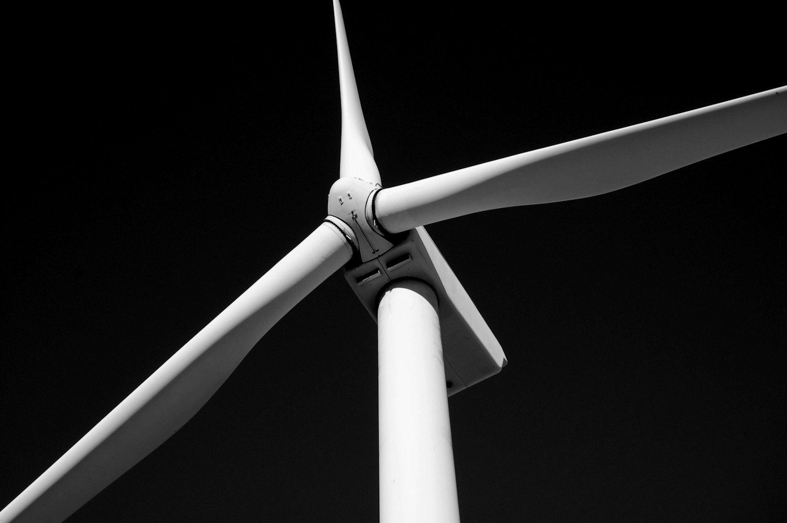 Wind turbine against a black sky